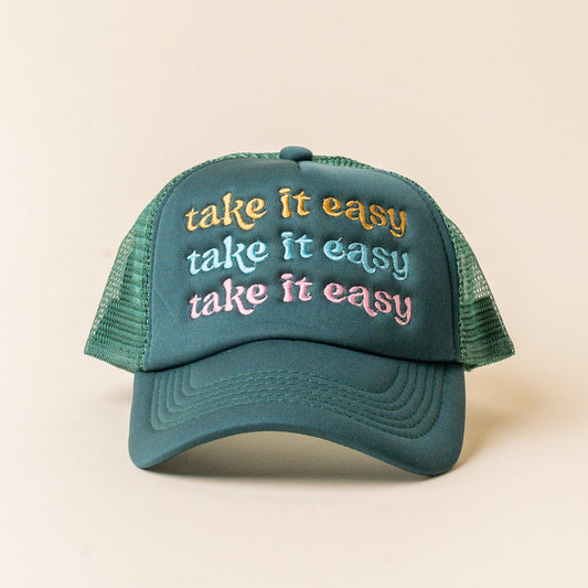 The Darling Effect's Take it Easy Trckr Hat features green mesh and "take it easy" embroidered three times in yellow, light blue, and pink—ideal for fans of trendy embroidered hats.
