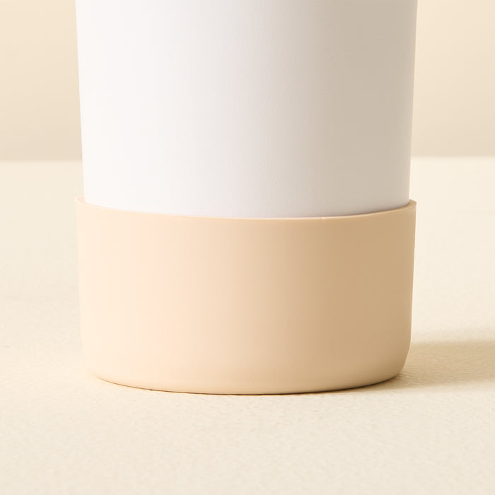 A close-up of The Darling Effect Tan Tumbler Silicone Boot, featuring a matte white upper and smooth beige base with a No-Slip Tumbler Boot for extra protection, shown on a matching beige surface against a plain background.