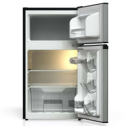 Open TCL 18 in. 3.1 Cu. Ft. Compact Top Freezer Mini Fridge in Silver (TRM31D4AV) with interior lights on a white background