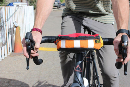 recycled hipster hip pack mounted on bike handlebars upcycled colorful versatile bikebag bikepacking