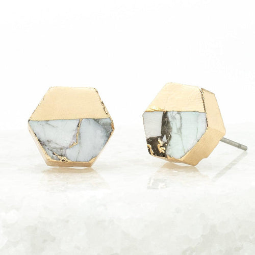 Hexagonal earrings with gold and marble design on a white background