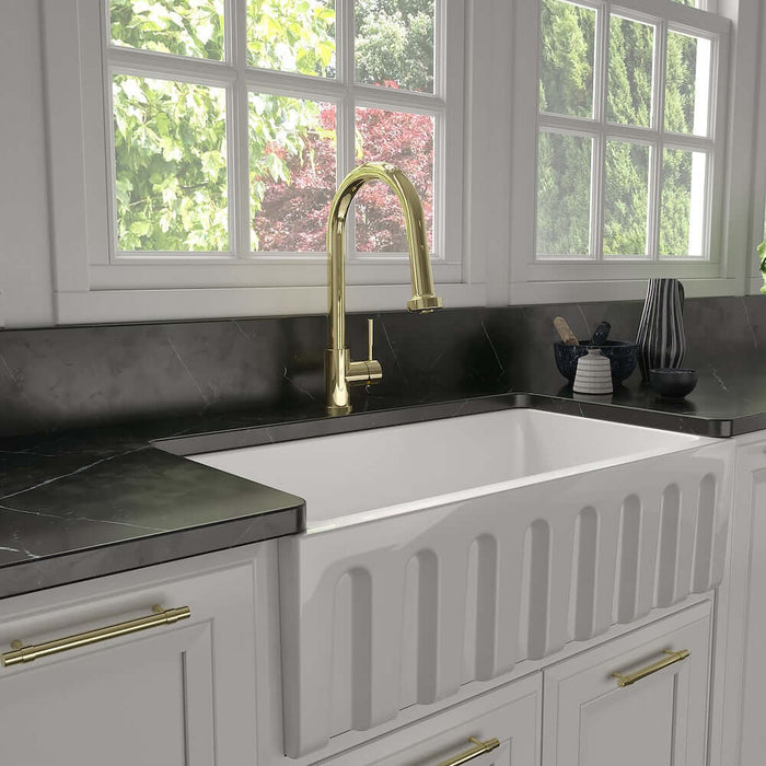Kitchen sink with ZLINE Monet Kitchen Faucet in Polished Gold (MON-KF-PG) and fixtures in a modern kitchen setting.